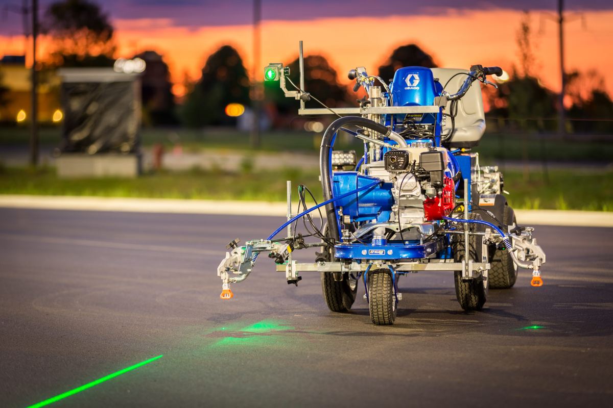 Walk-behind striping machine laying a line